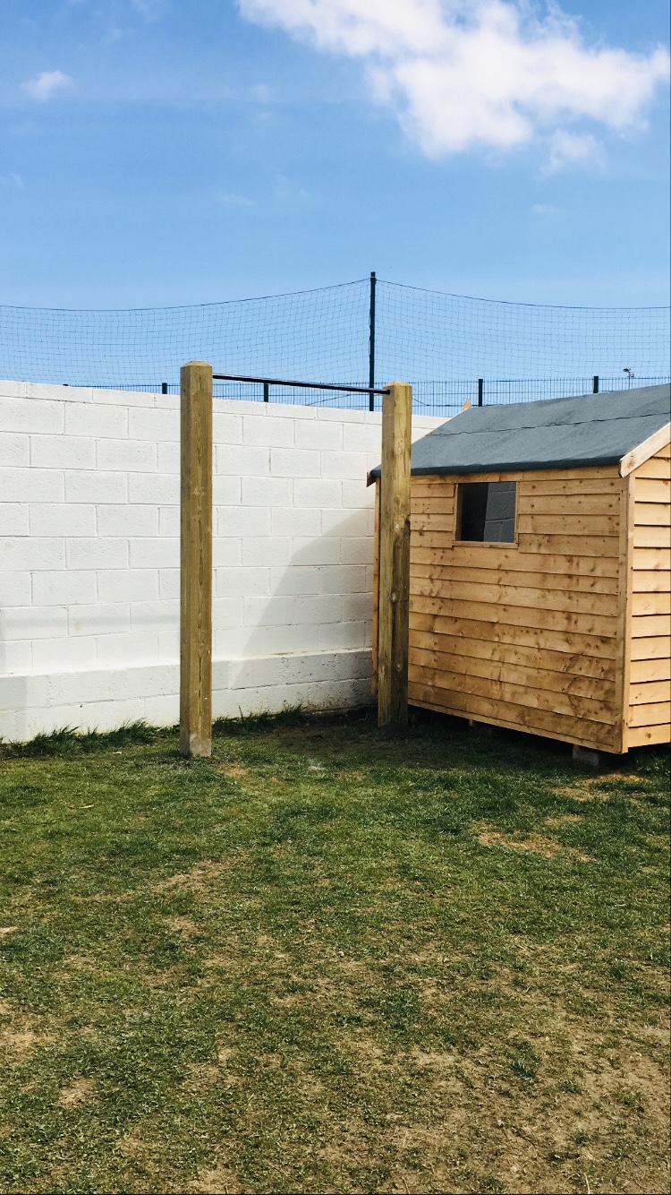 Timber outdoor pull-up bar equipment in a private garden